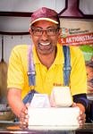 picture of Elias Mamo, selling cheese in his stall at Erlangen's Martkplat