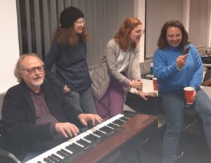 Picture of musical entertainment by Prof. Bielefeldt (piano) and three women.