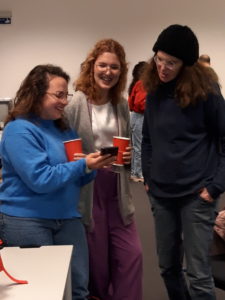 Picture of three female students at the end-of-the-year celebration with red cups.