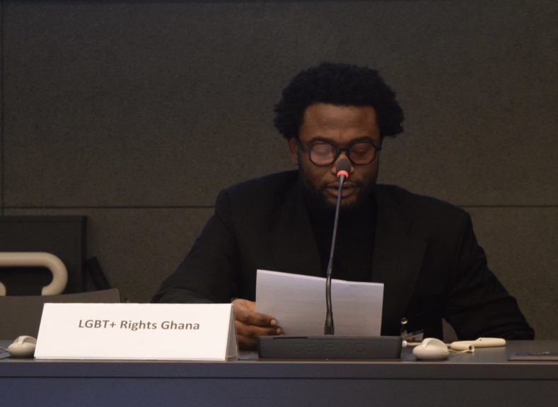 Picture of M.A. Human Rights Student, Abdul-Wadud Mohammed speaking at United Nationswith sign LGBT+ Rights Ghana.