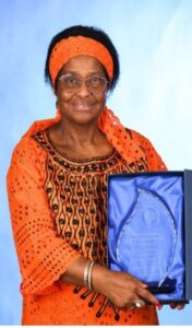 Picture of Dr Pierrette Herzberger-Fofanaholding award.