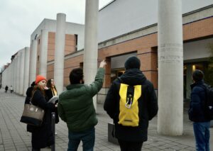 Tour guide and MA Human Rights student discussing the articles engraved into the collar on the "Way of Human Rights"