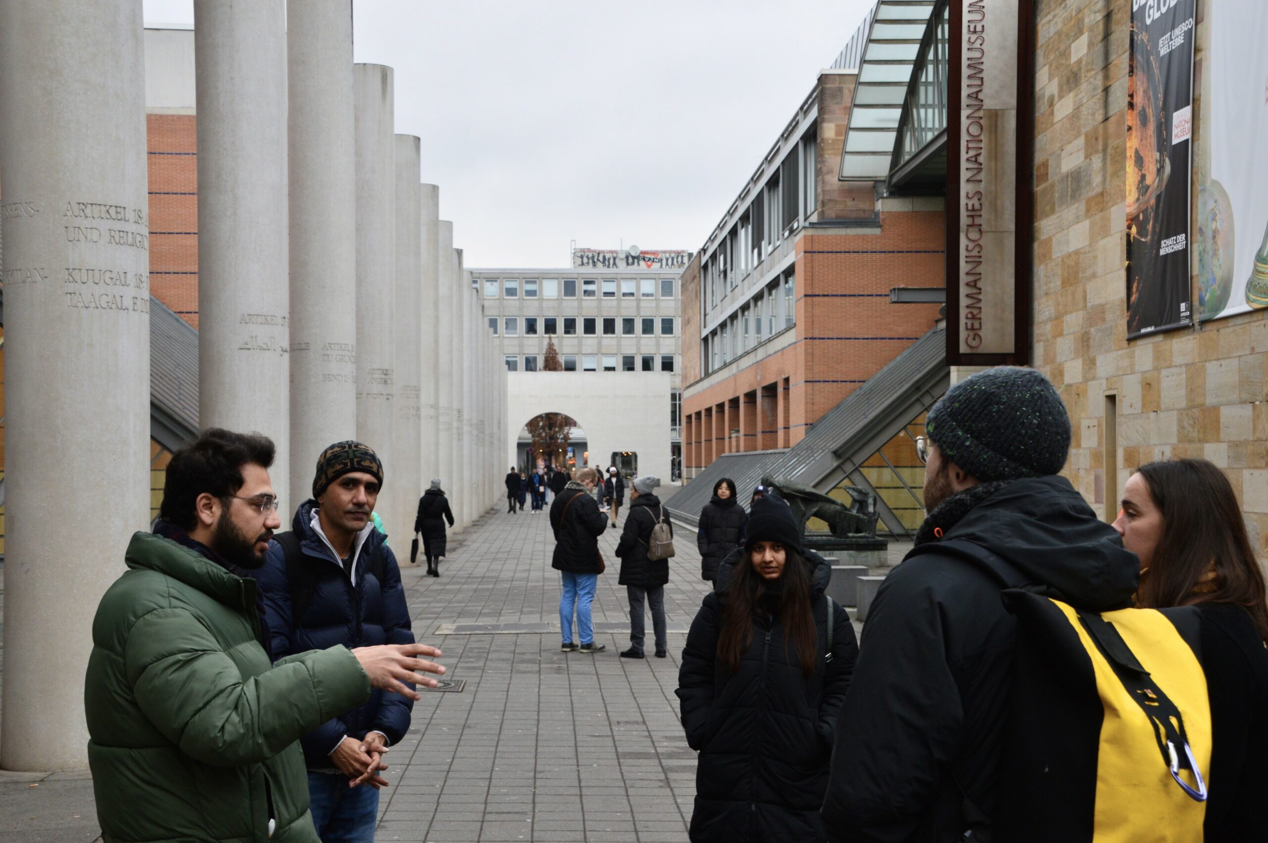 Tour guide and MA Human Rights student discussing the articles engraved into the collar on the "Way of Human Rights"