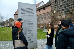 students and tour guides discussing memorium at the end of human rights way